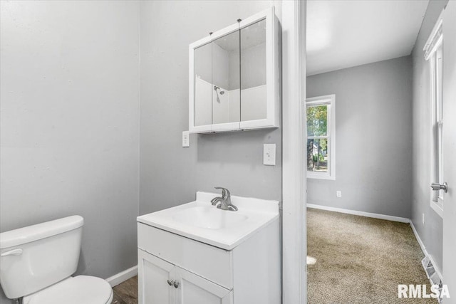 bathroom featuring vanity and toilet