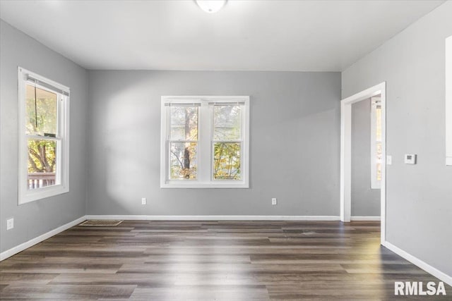 spare room featuring dark hardwood / wood-style floors