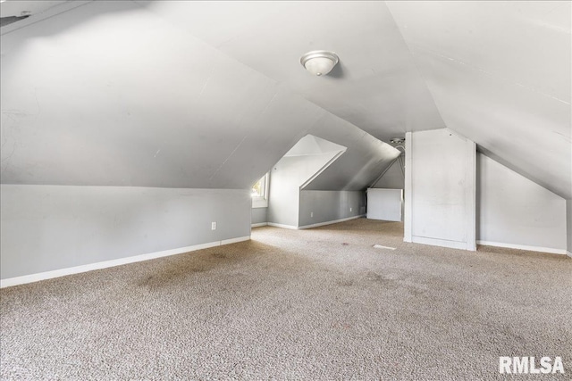 bonus room featuring carpet and vaulted ceiling