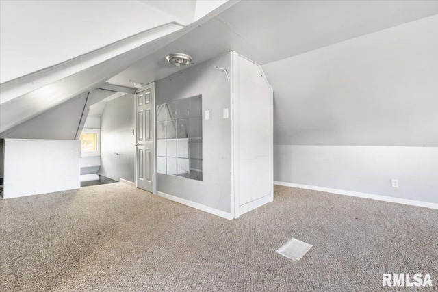 bonus room with lofted ceiling and carpet flooring