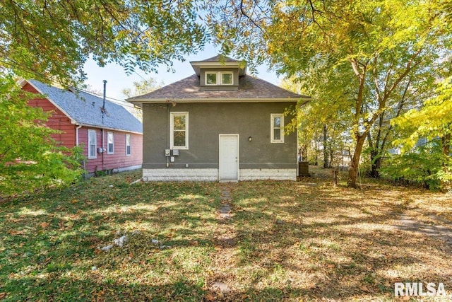 back of property featuring a lawn