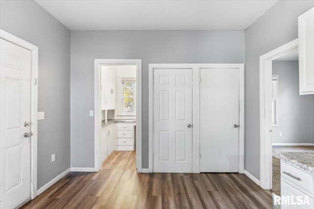 unfurnished bedroom featuring dark wood-type flooring