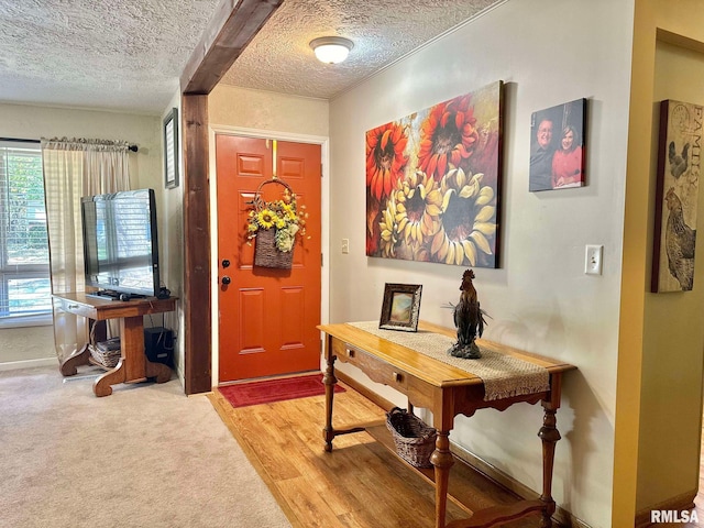 entryway with a textured ceiling and wood-type flooring