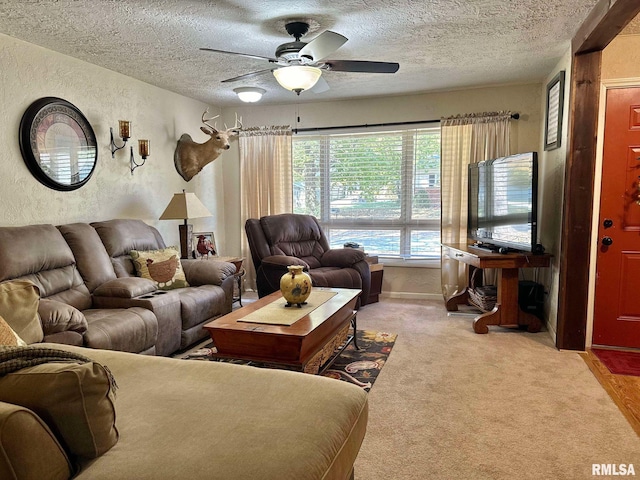 carpeted living room with a textured ceiling and ceiling fan