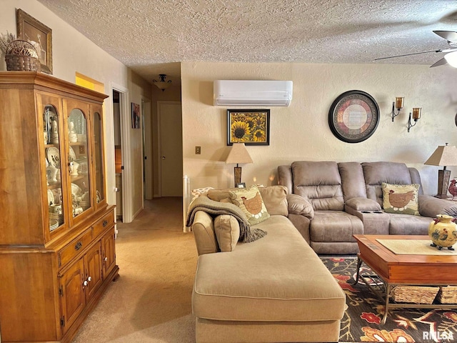 carpeted living room featuring a wall unit AC, a textured ceiling, and ceiling fan