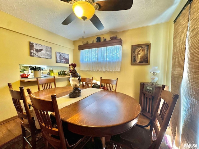 dining space featuring a textured ceiling, hardwood / wood-style flooring, and ceiling fan