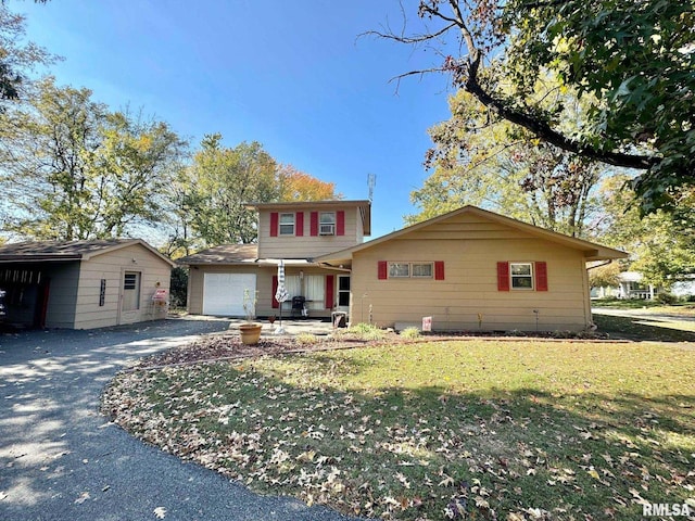 view of front of home with a front yard and a garage