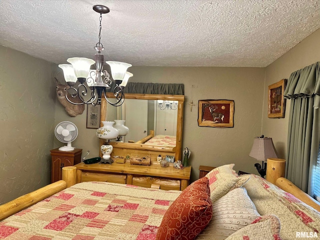 bedroom with a notable chandelier and a textured ceiling