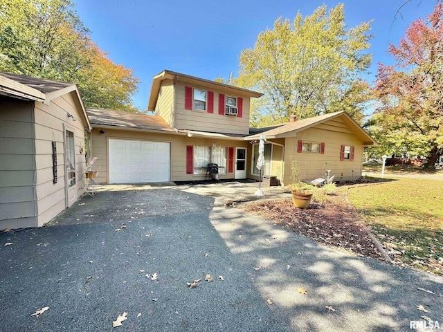 view of property with cooling unit and a garage