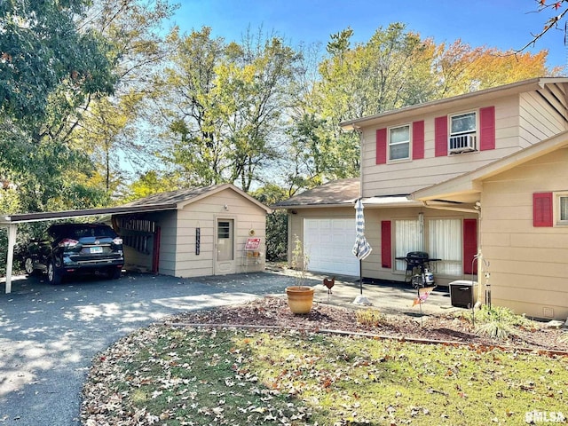 view of front of house with a garage and a carport