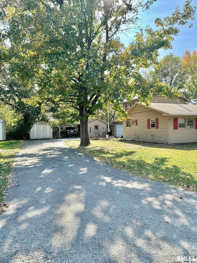 view of side of property with a yard and a shed