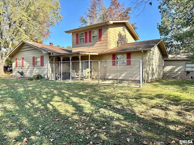 back of property featuring a yard