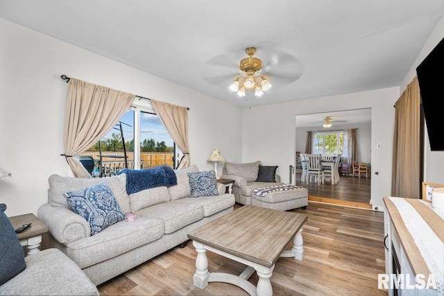 living room featuring hardwood / wood-style flooring, plenty of natural light, and ceiling fan