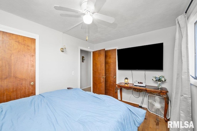 bedroom with wood-type flooring and ceiling fan