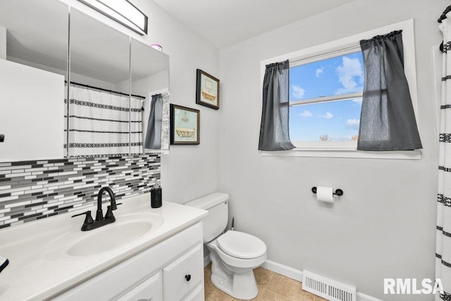 bathroom with vanity, toilet, tasteful backsplash, and tile patterned floors