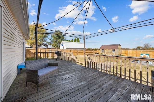 wooden terrace with a storage shed