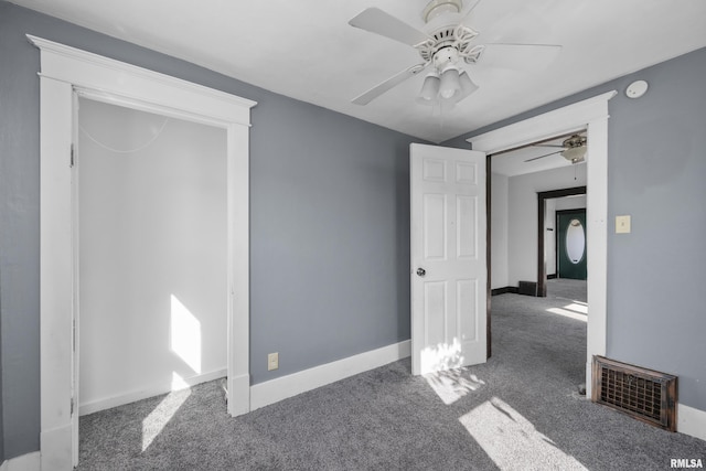 empty room with carpet flooring and ceiling fan