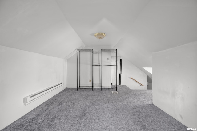 additional living space featuring lofted ceiling, a baseboard heating unit, and carpet floors