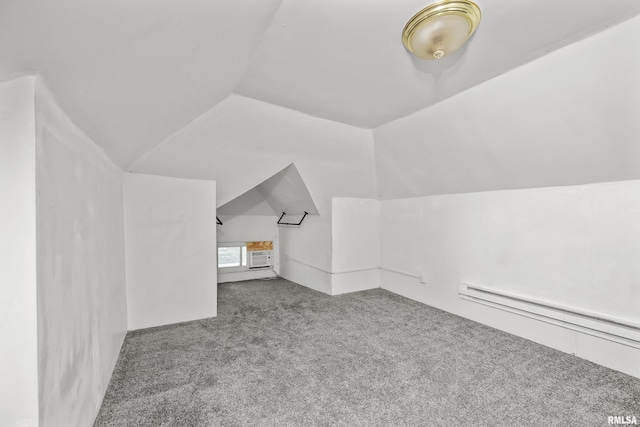 bonus room featuring baseboard heating, carpet, and vaulted ceiling