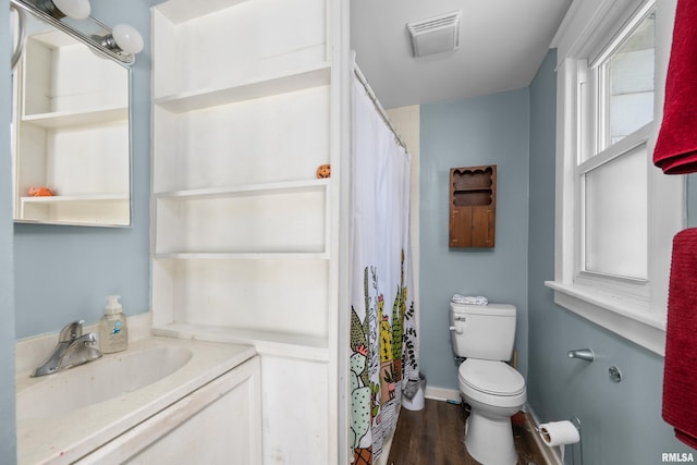 bathroom with toilet, hardwood / wood-style flooring, and vanity