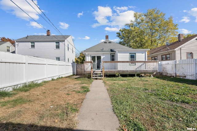 back of house with a yard and a deck