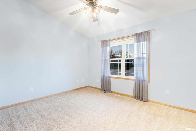 empty room with carpet, lofted ceiling, and ceiling fan