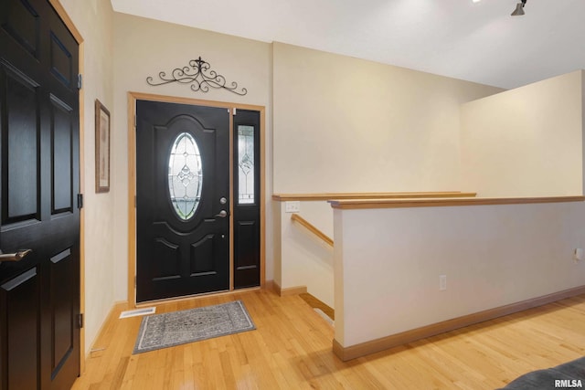 foyer entrance with light hardwood / wood-style floors