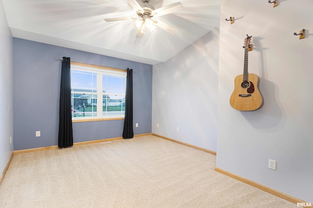 carpeted empty room with ceiling fan and lofted ceiling