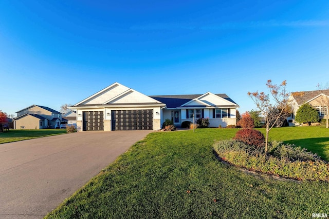 ranch-style house featuring a front lawn and a garage