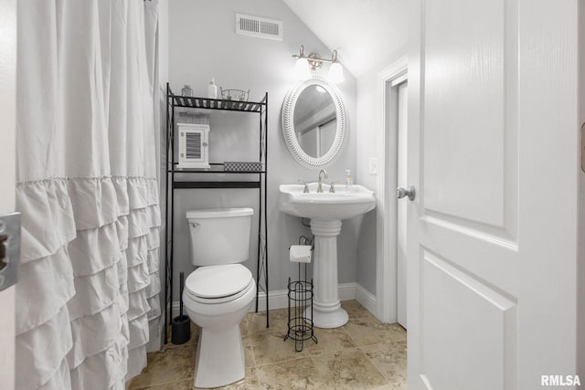 bathroom with toilet and vaulted ceiling