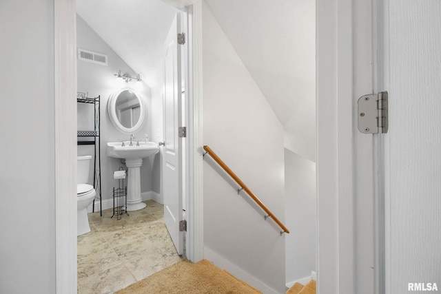 bathroom featuring toilet and vaulted ceiling