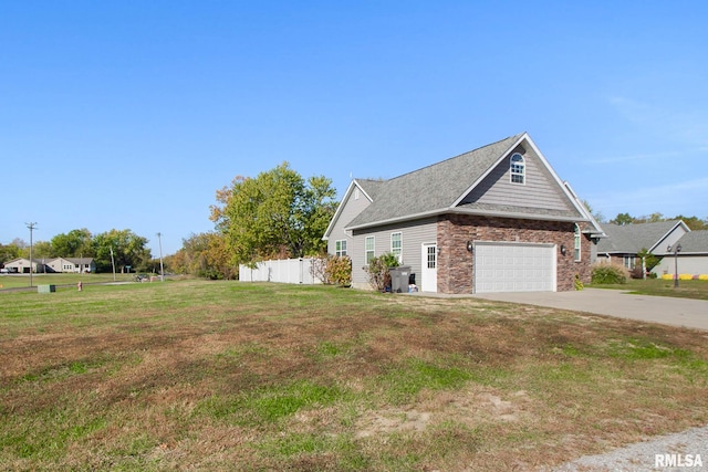 view of home's exterior with a yard and a garage