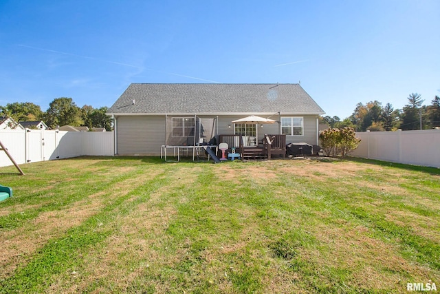 back of property featuring a lawn