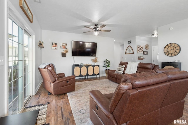 living room with light wood-type flooring and ceiling fan