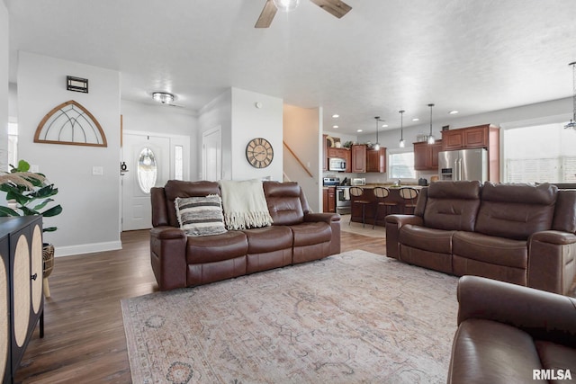 living room with dark hardwood / wood-style floors and ceiling fan