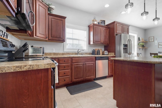 kitchen featuring light tile patterned floors, stainless steel appliances, sink, and pendant lighting