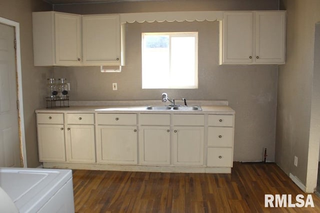 kitchen with dark hardwood / wood-style flooring, white cabinetry, and sink