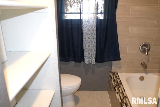 bathroom with tile patterned flooring, shower / bath combo, and toilet