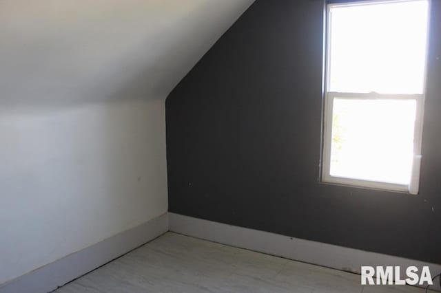 additional living space featuring vaulted ceiling