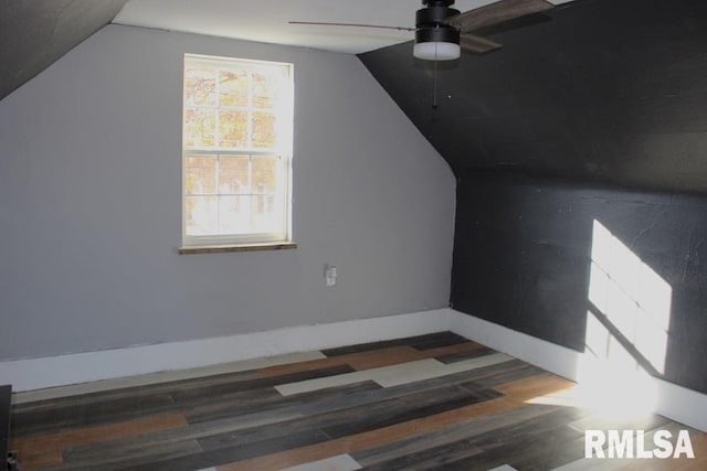 additional living space featuring vaulted ceiling, ceiling fan, and dark hardwood / wood-style floors