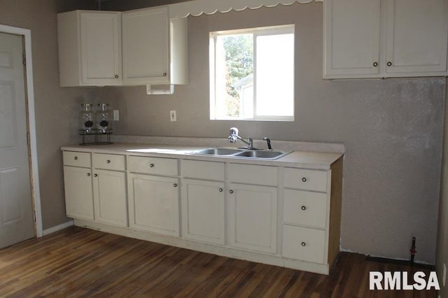 kitchen featuring white cabinetry, sink, and dark wood-type flooring