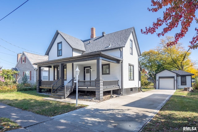 view of front of home with a porch, a front lawn, an outdoor structure, and a garage