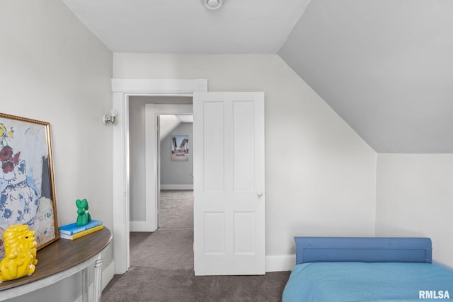 bedroom featuring lofted ceiling and dark colored carpet