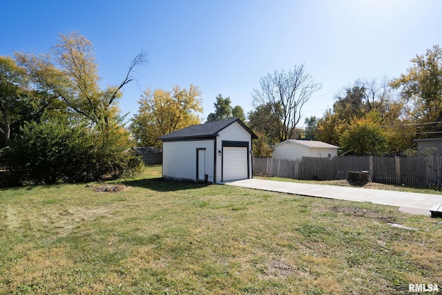 view of yard featuring an outbuilding and a garage