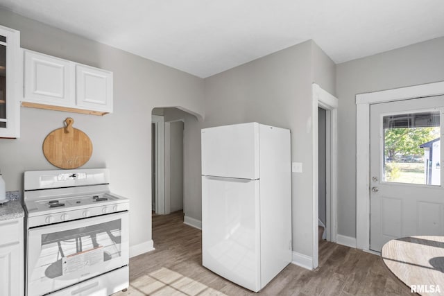 kitchen featuring white cabinets, white appliances, and light hardwood / wood-style flooring