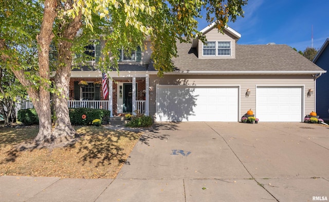 view of front of home featuring a porch and a garage