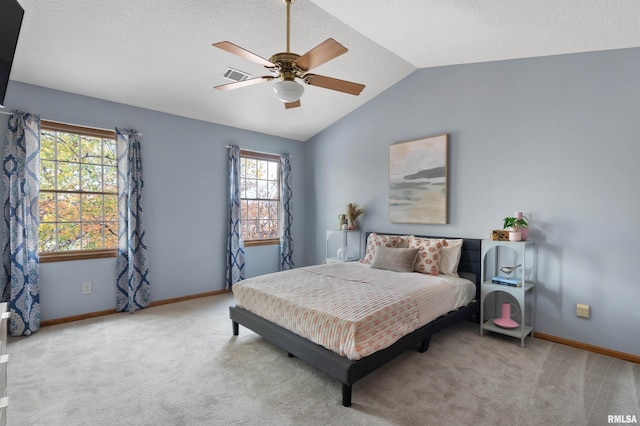 bedroom featuring ceiling fan, light carpet, and vaulted ceiling