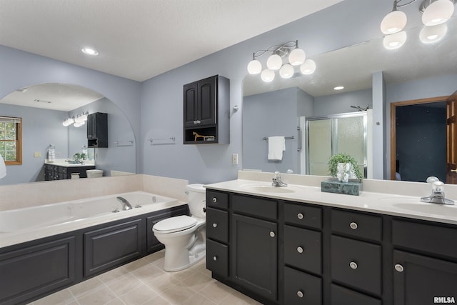 full bathroom with toilet, vanity, and separate shower and tub