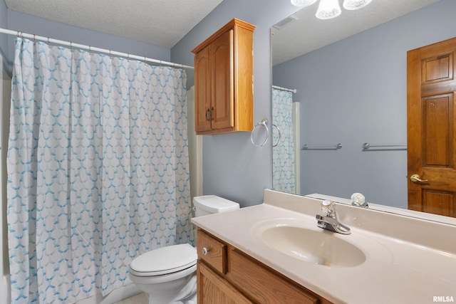 bathroom featuring vanity, a shower with curtain, a textured ceiling, and toilet