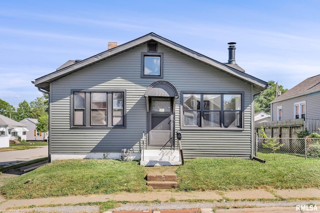 bungalow-style home with a front yard